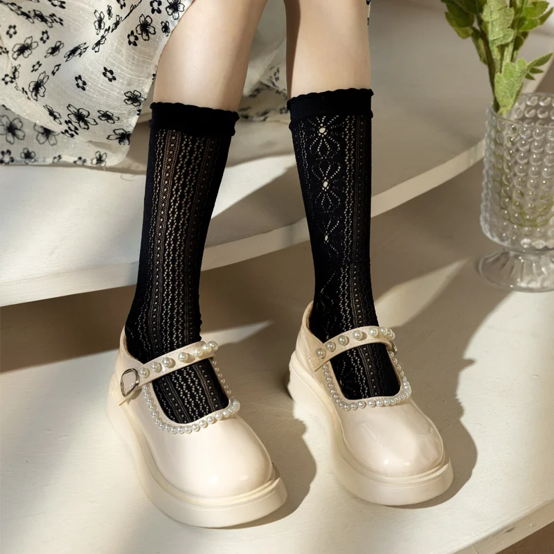 

A pair of summer thin children's socks with a versatile Korean style, featuring daisy lace and mesh design for the lower leg