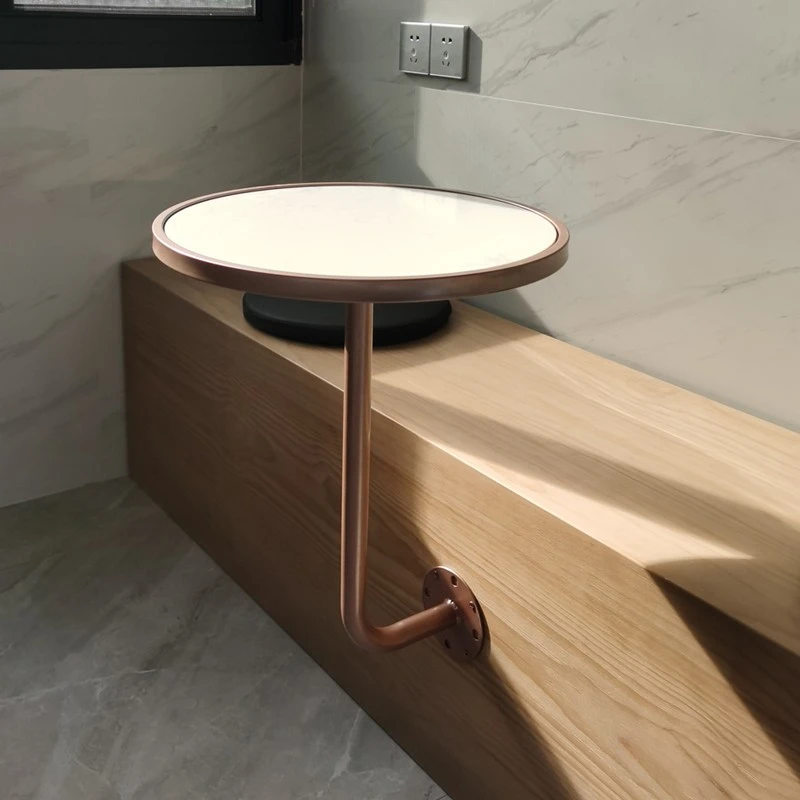 

The side of the card seat is hung against wall, corner of the cafe is a small marble round table, rose gold small table