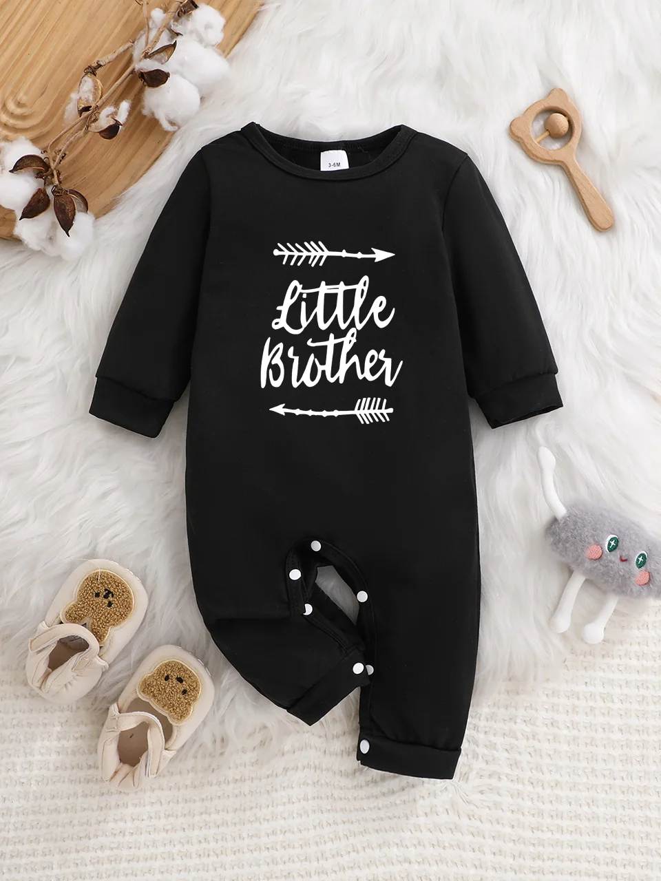 A baby long-sleeved onesie with interesting letter prints. It features a buttoned design for easy putting on and taking off