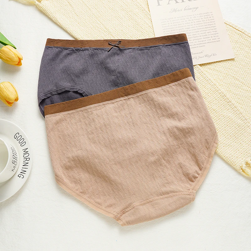 سراويل داخلية نسائية عالية التمدد ذات تغطية كاملة متوسطة الخصر بدون خياطة من مزيج القطن الملون بفيونكة مناسبة لـ 45-65 كجم