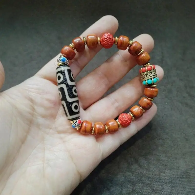 Antique collectibles Tibetan-style with a patina from being stored for a long time featuring a red cinnabar bracelet