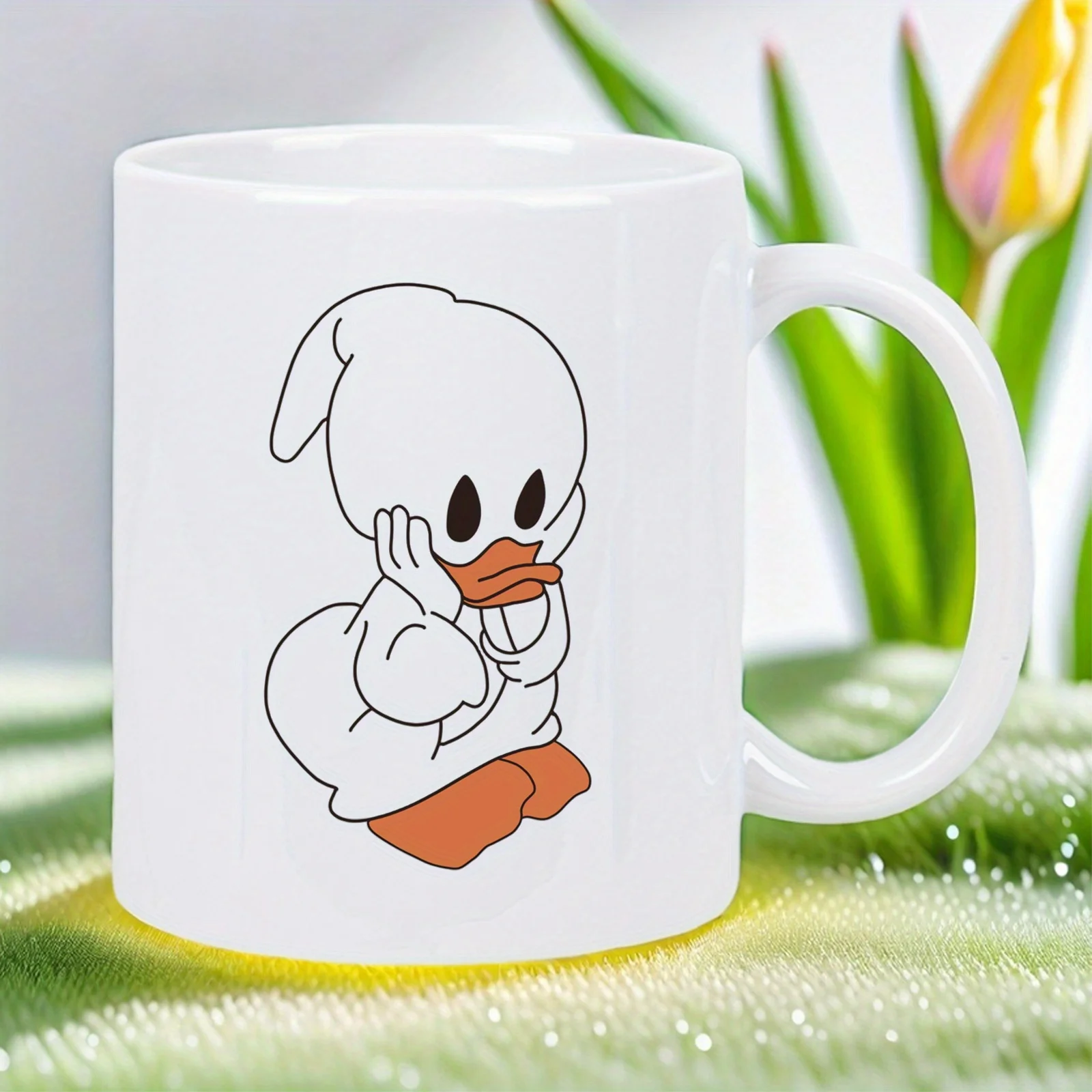 This white ceramic mug features a cute duck design, is reusable, and is suitable for home, office, or as a gift.