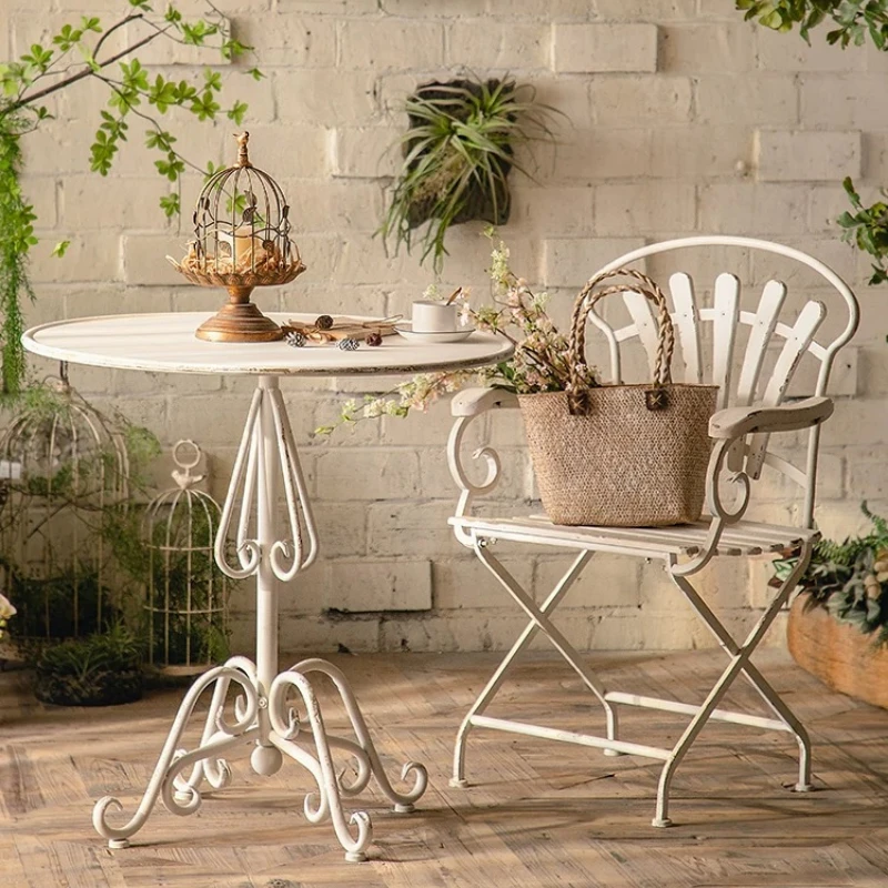 Vintage made old Monet garden outdoor courtyard wrought iron balcony small round table chair