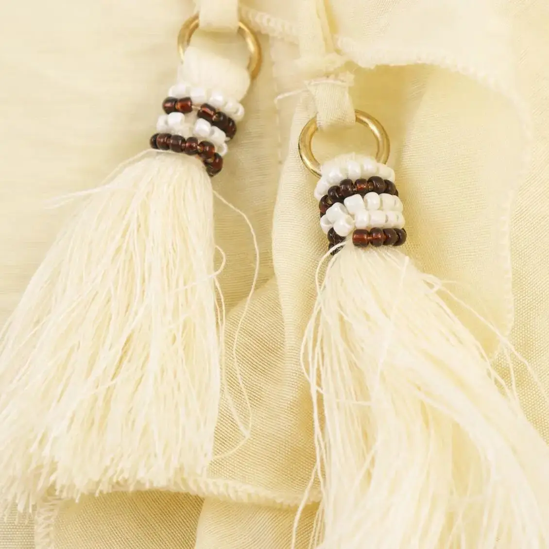 เสื้อแฟชั่นผู้หญิงสไตล์ยุโรปและอเมริกา ประจำปี 2025 รุ่นใหม่สำหรับฤดูใบไม้ร่วง ตกแต่งพู่เก๋ไก๋ คอกลม แต่งลายเคลือบ