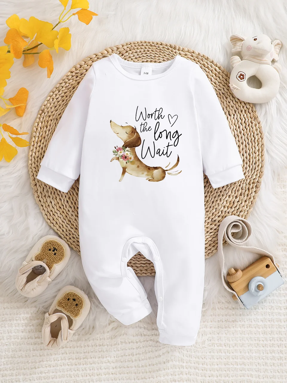A baby long-sleeved onesie with interesting letter prints. It features a buttoned design for easy putting on and taking off, and