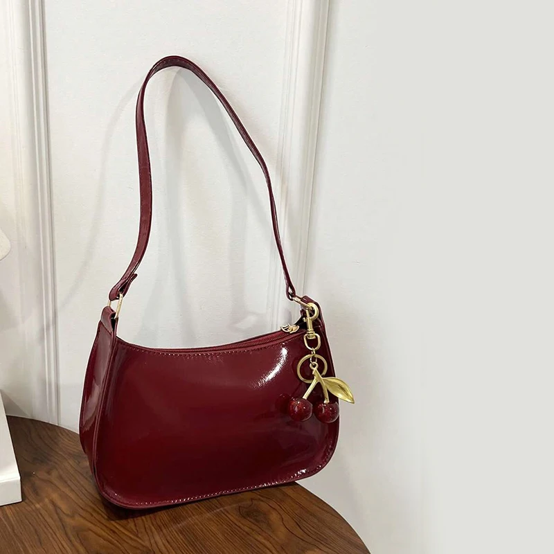 Bolsos de hombro de piel sintética de Color liso para mujer, bolsos con colgante de cereza a la moda, bolso de diseño informal para mujer, bolso Hobos para axila