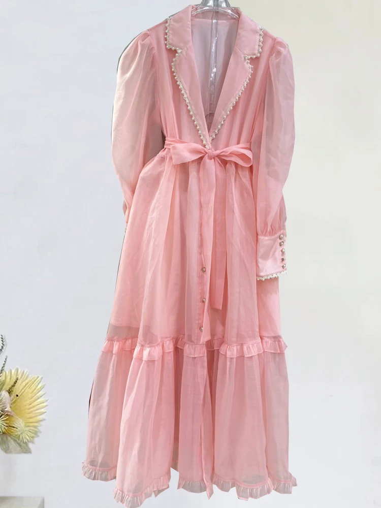 

In the autumn of 2025, the new V-neck beaded long-sleeved single-breasted dress is tied with a waist and a long fluffy shirt ski