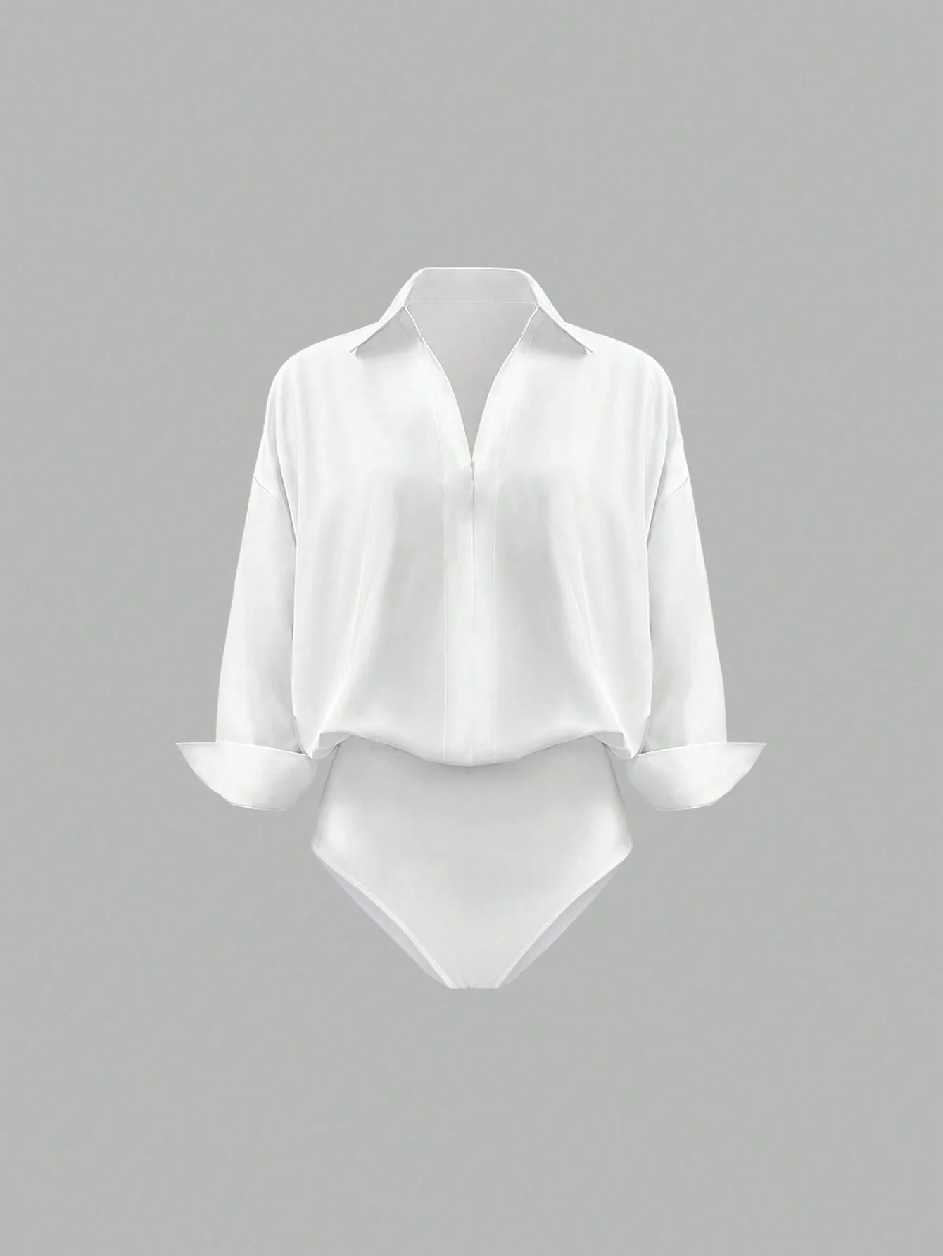 Oversized solid-colored jumpsuit with long sleeves in a versatile shirt style