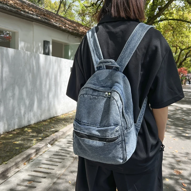 A classic popular solid color denim backpack, comfortable fabric, large capacity, suitable for business travel commuting shoppin