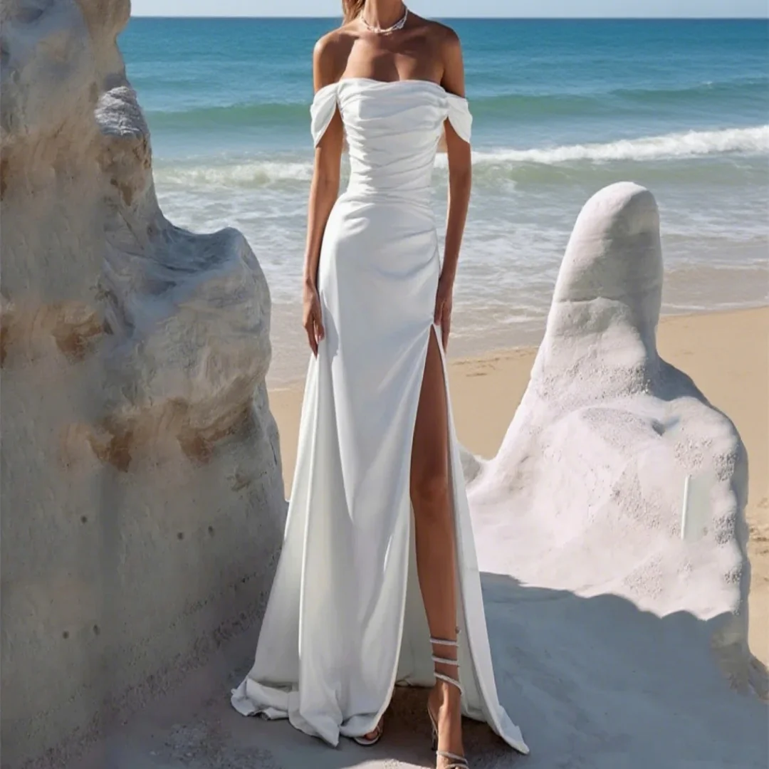 Customize an elegant off-shoulder mermaid-style wedding dress with pleated slit. This is the formal evening gown for the bride.