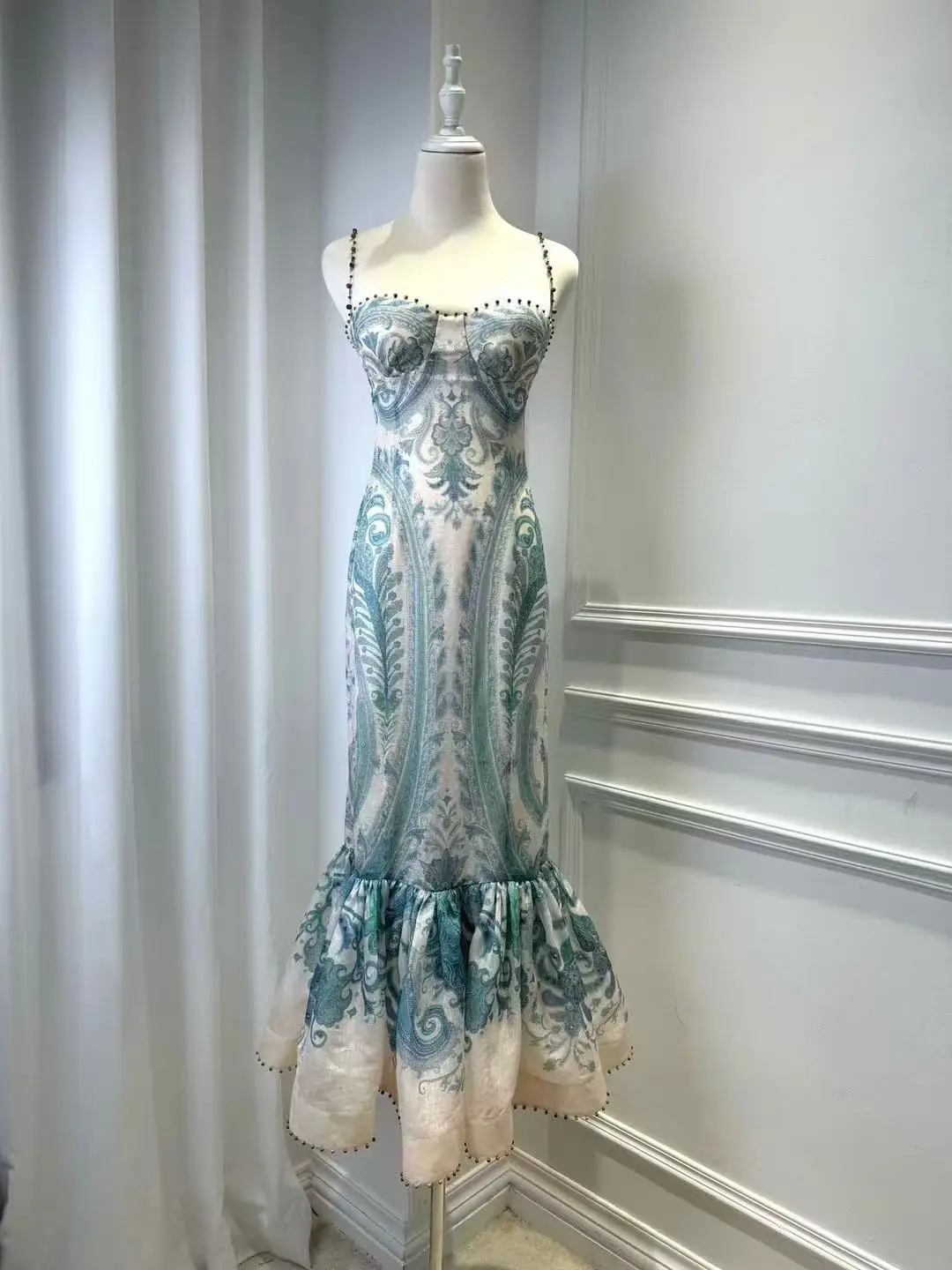 

A long and elegant dress with turquoise printed halter fishtail hem for Spring/Summer 2025