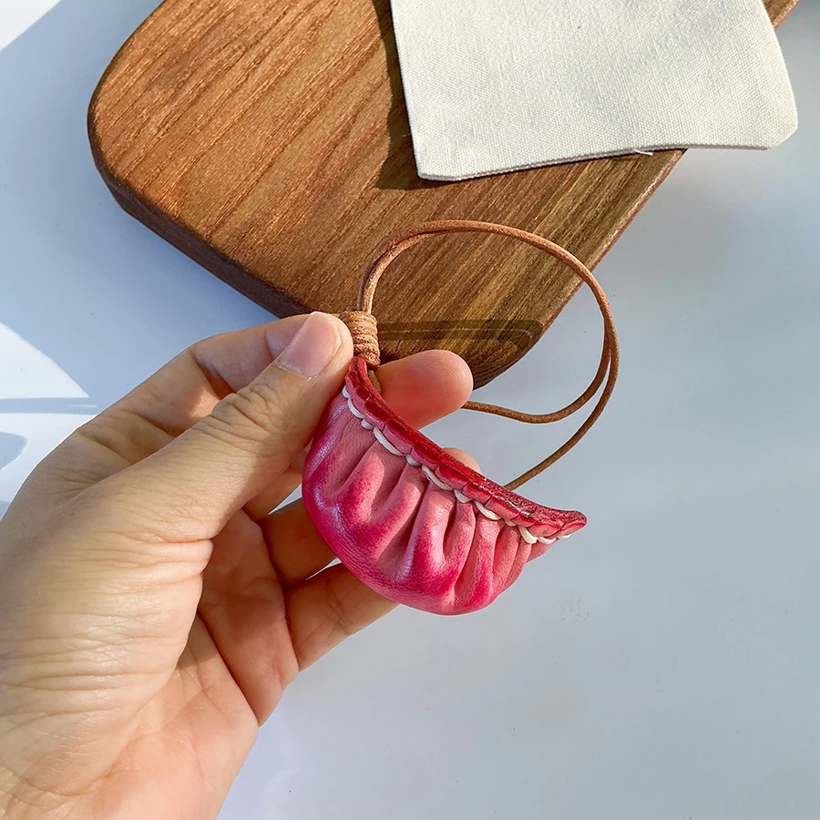 

Декоративный брелок-подвеска из натуральной кожи растительного дубления в форме пельменя для сумки или автомобиля