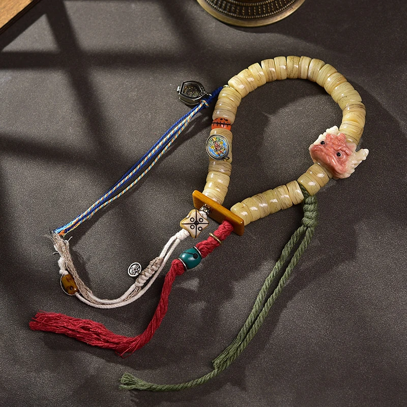 A Tibetan-style camel bone bracelet inlaid with copper and old silver, decorated with dzi beads, and featuring a single-loop han