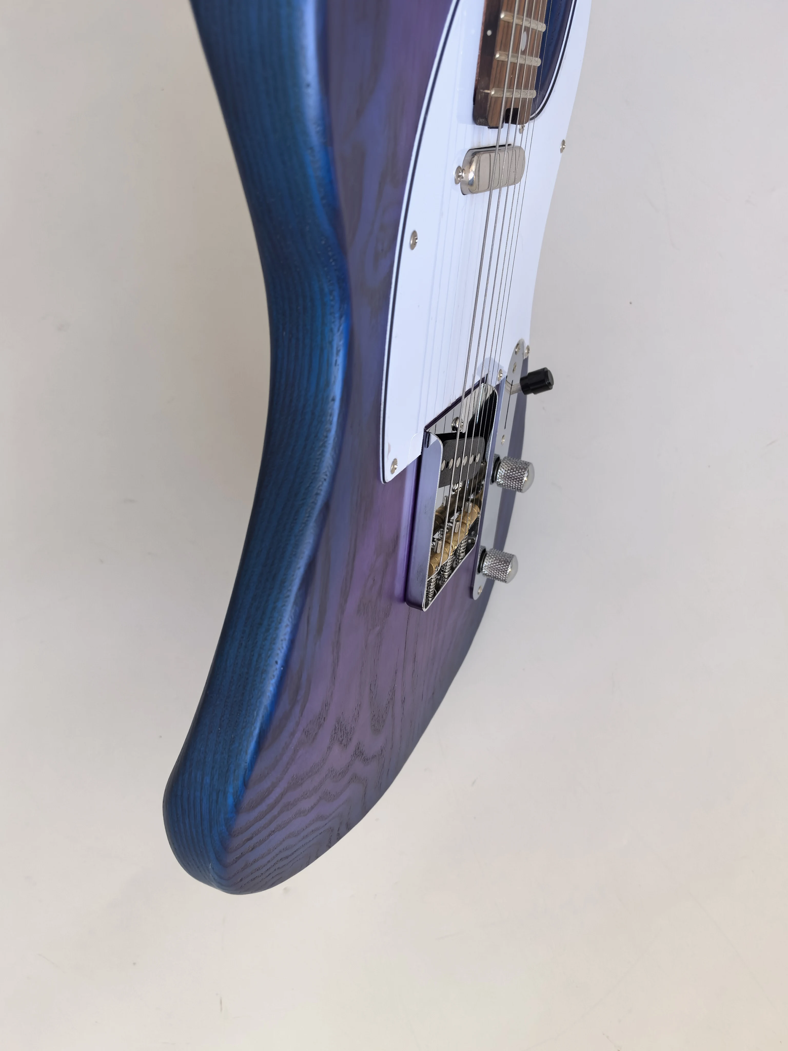 In Stock:  Matte Blue Circle Purple 6-string Ash Wood Electric Guitar, Rosewood Fingerboard, Rear Lock String Lute Button.