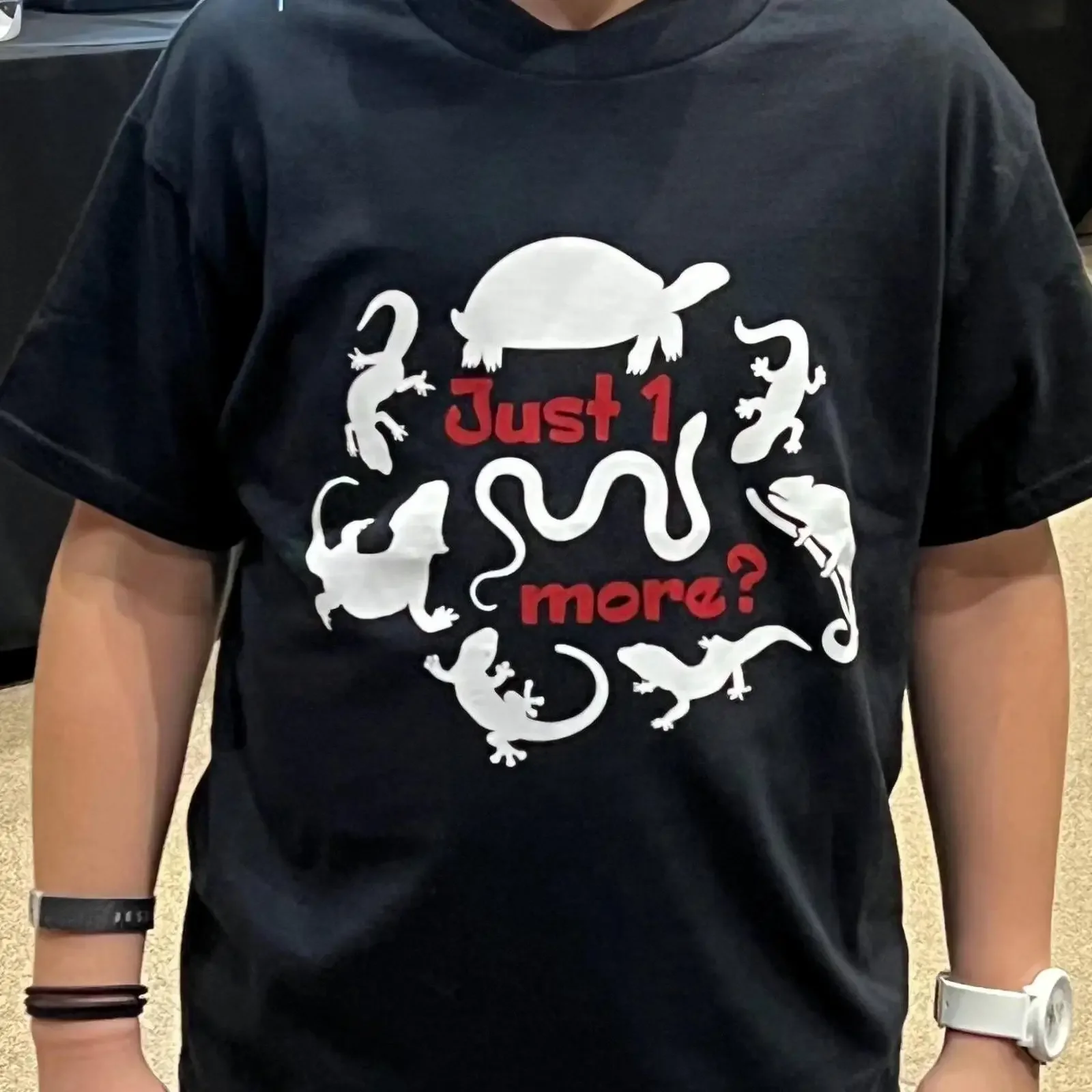 May include Black t shirt with a white graphic of turtle snake and lizards The text Just 1 more is written in red vintage
