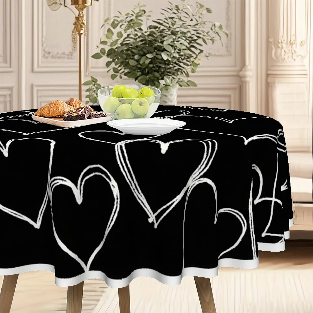 The circular tablecloth features a white heart-themed design with a black background.
