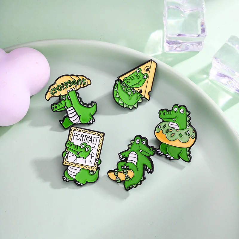 Cute crocodile delivered a giant croissant wrapped in a swim ring and cool skateboarding crocodile  brooch