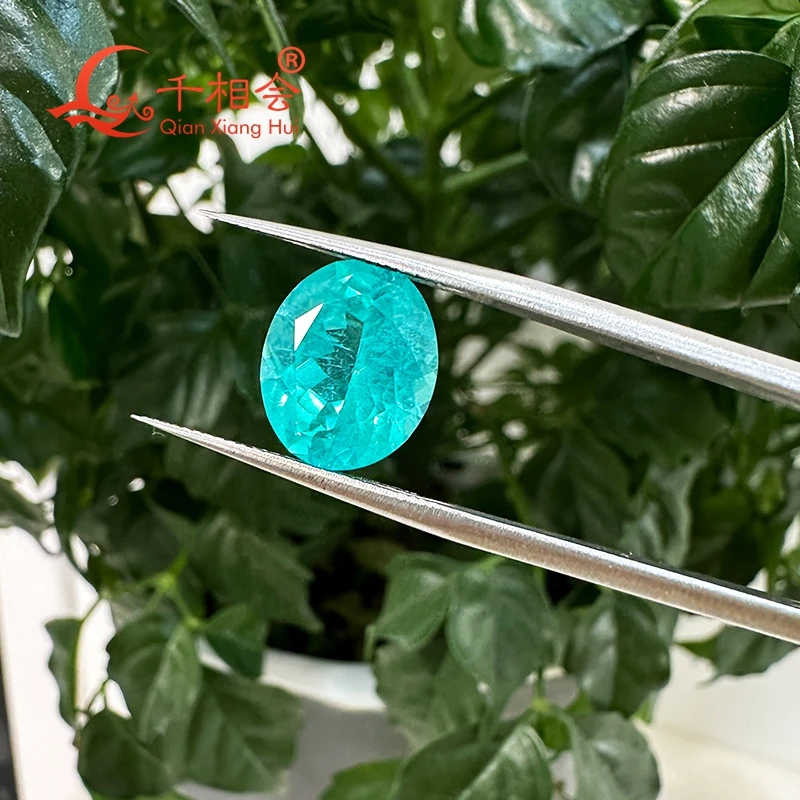 

oval shape Paraiba with a neon glow lab grown Yttrium Aluminum Garnet with inclusions Neon-like gem stone jewelry YAG