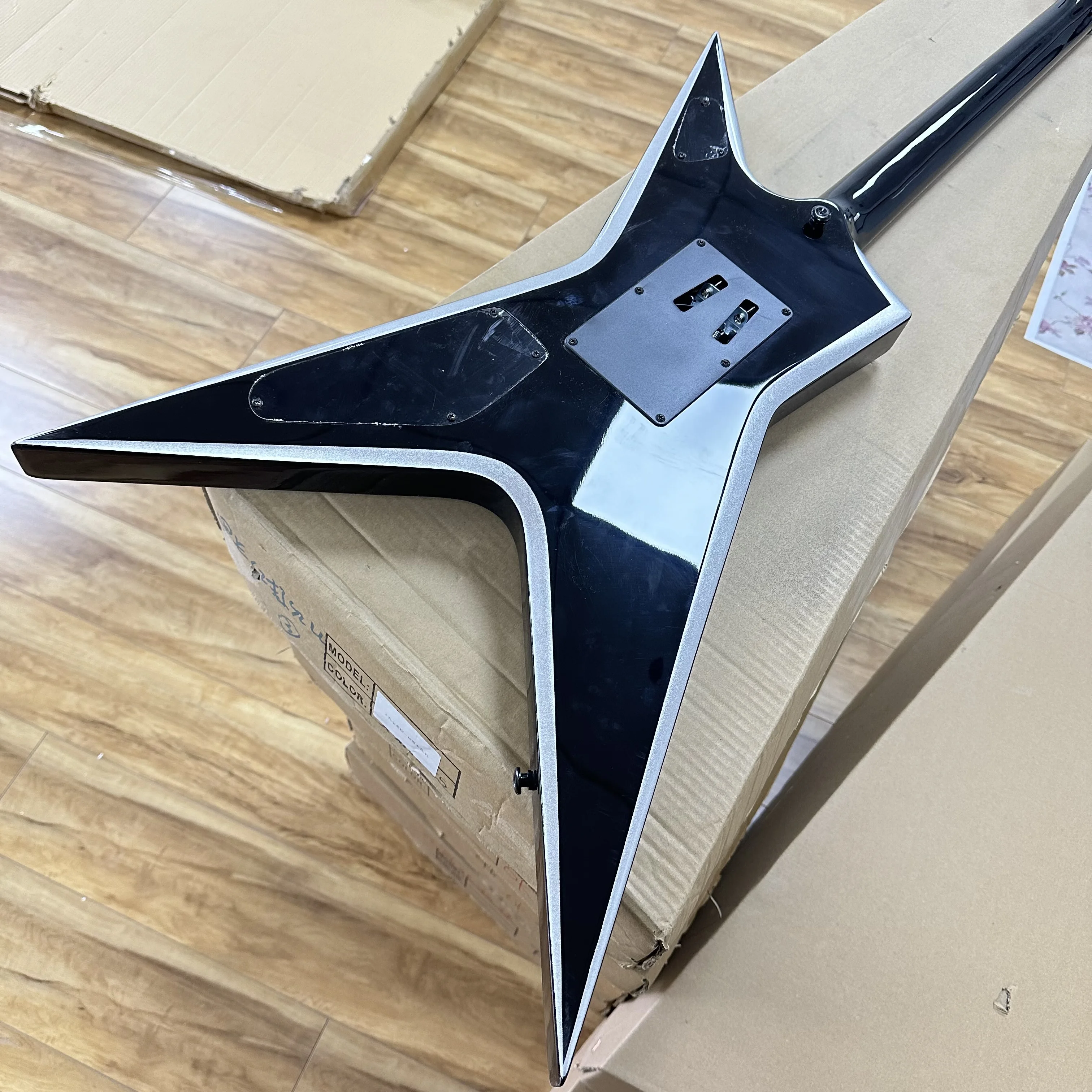 Star V Shape Electric Guitar Black with Silver Binding Double Humbucker Tremolo Metal Guitar In Storck