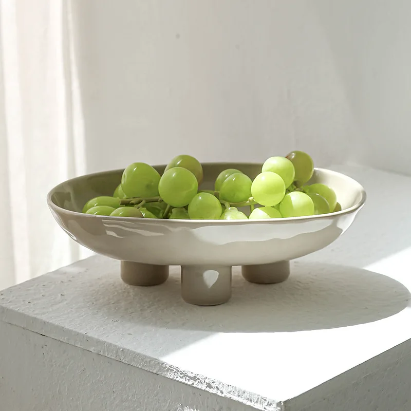 

Modern simple and creative hand-squeezed ceramic three-legged high fruit plate, home living room entrance desktop fruit plate