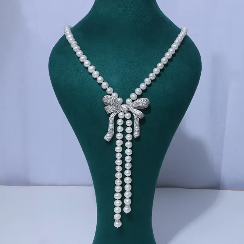 

28-30“ Women's White Freshwater pearl bow Cz sweater chain necklace