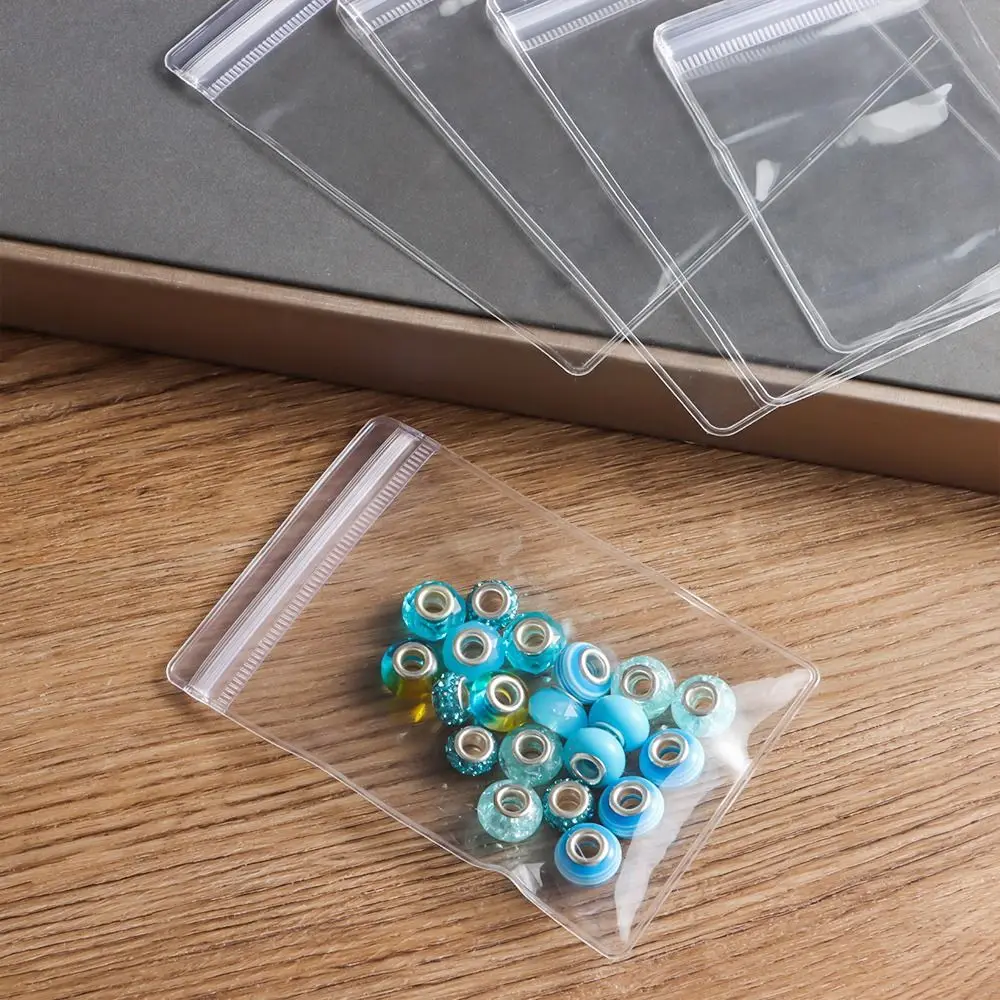 100 Stück neue selbstverschließende PVC-Kunststoffbeutel, staubdicht, wiederverschließbar, mit Reißverschluss, transparente Schmucktasche, Armband, Ring – Detail 10
