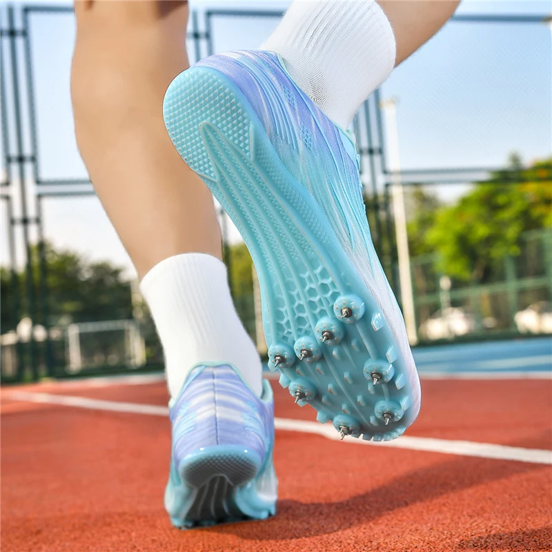 รองเท้ากรีฑาลักหุ่งสำหรับผู้ชายและผู้หญิงรุ่นใหม่ พร้อมปุ่มสำหรับการวิ่งแข่ง กระโดดข้ามรั้ว กระโดดไกล การฝึกซ้อมในสนาม และการแข่งขัน