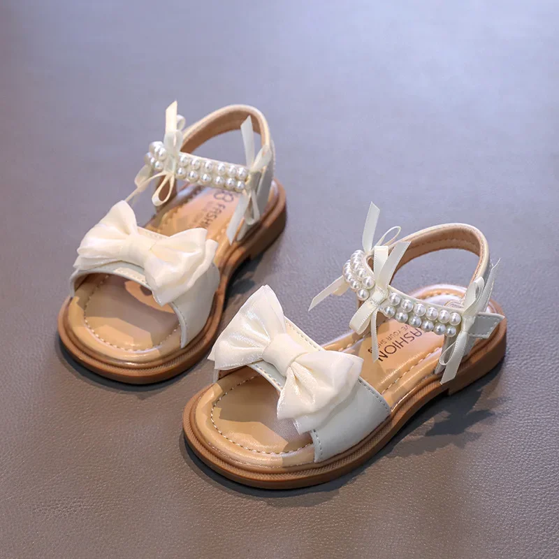 

Сандалии принцессы для девочек, новинка 2023 года, летние детские модные сандалии с жемчужным бантом, нескользящая детская повседневная пляжная обувь с мягкой подошвой