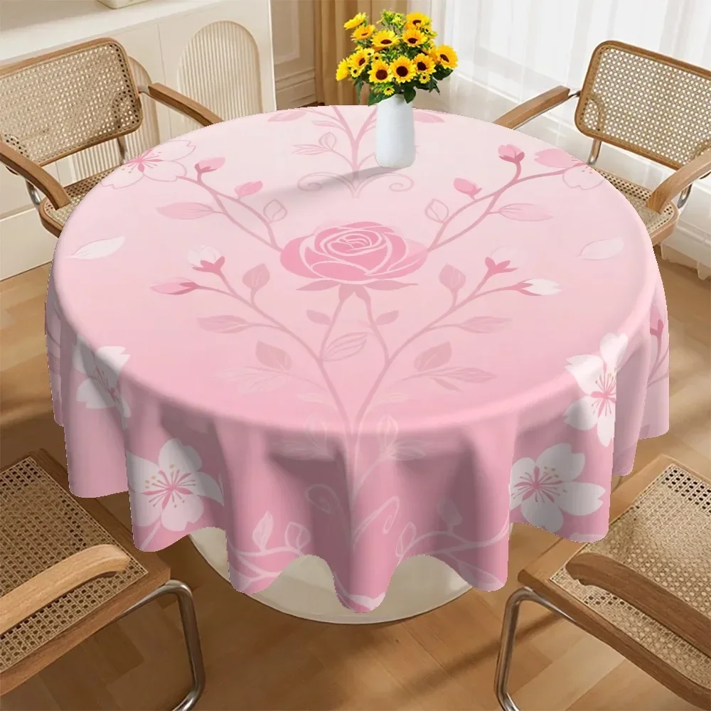 A round tablecloth, featuring a pink floral design with patterns of roses and cherry blossoms.