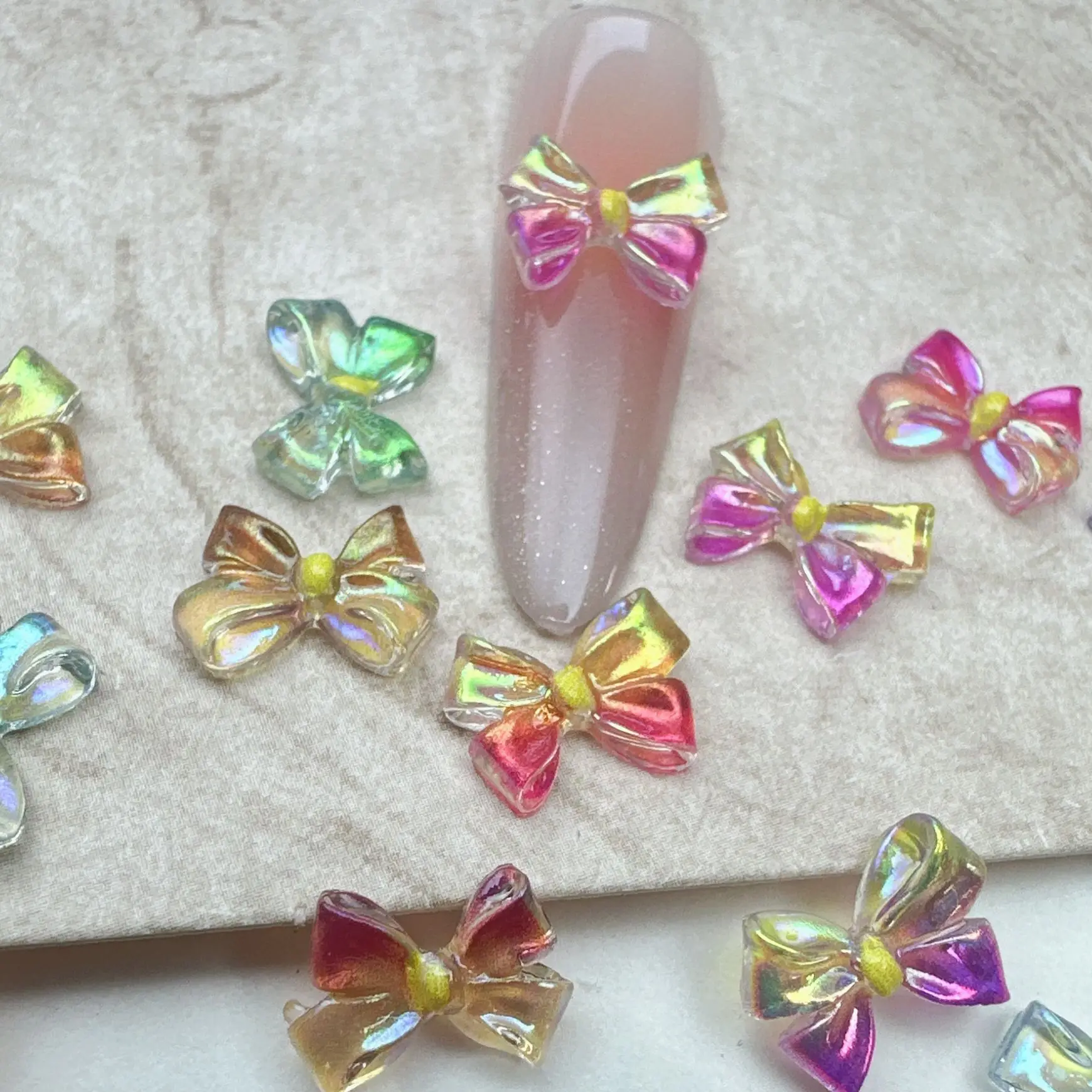 100 pezzi/pacco 2026 ciondoli per unghie con fiocco in resina iridescente - Aurora Butterfly Nail Art, decorazione per unghie a pressione futuristica per manicure fai da te