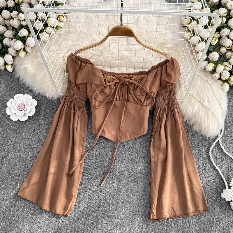 Image of Crop Tops Einfarbige Sexy Blusen Damenmode 2025 Blusas Mujer De Moda Schulterfrei Trompetenärmel Bandage Chic Blusenhemden