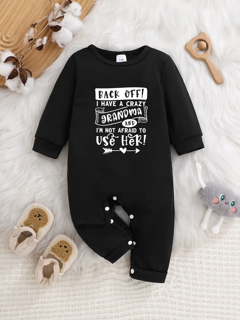 Baby long-sleeved bodysuit with fun letter prints, button design, easy care, suitable for new parents.