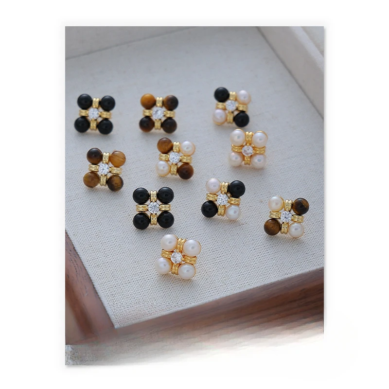 

Light luxury temperament tiger's eye earrings imitation pearl inlaid zircon four-petal earrings