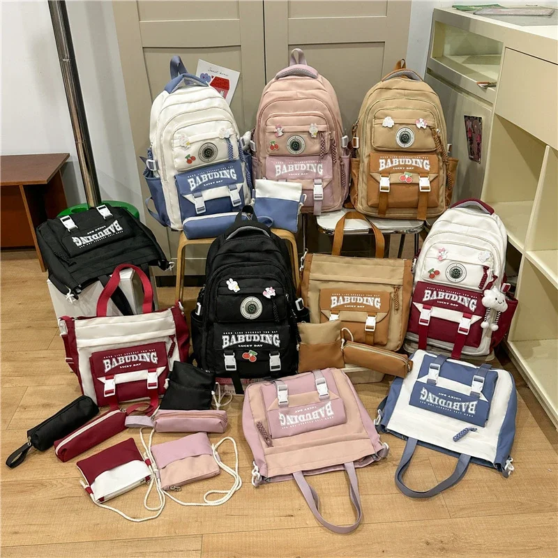 2025 Set di borse da scuola con manico morbido in nylon per la stagione del ritorno a scuola di alta qualità, combinazione di zaini casual con struttura esterna con cerniera solida