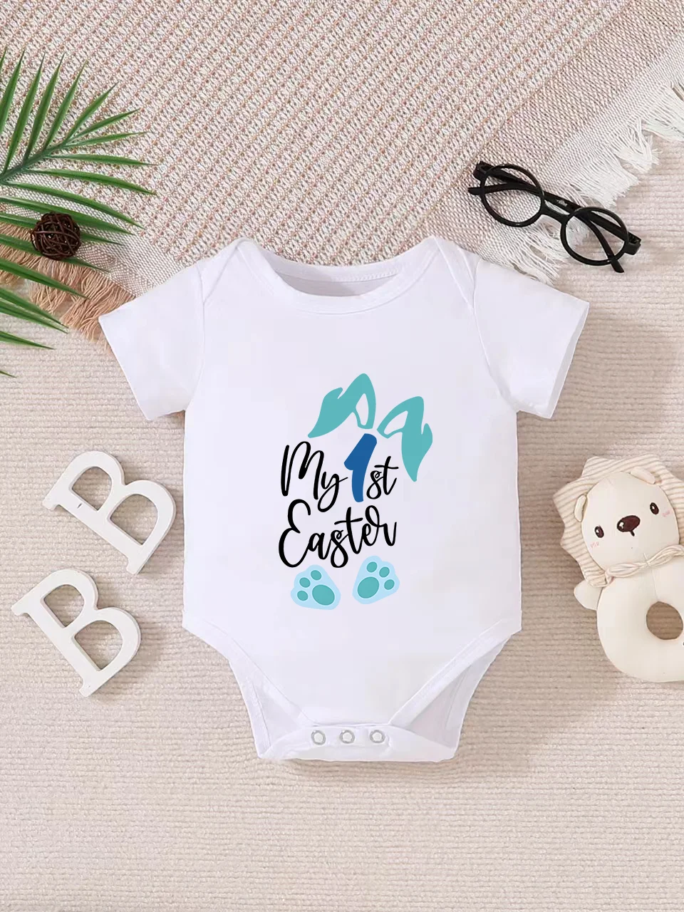 Playful letter-printed baby short-sleeve triangle bodysuit. Button closure for easy dressing, machine washable