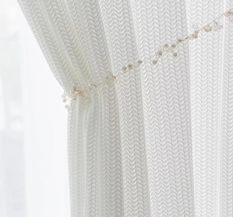 Custom Sized Curtains Featuring A Cut-out Herringbone Design That Allows Light To Filter Through While Ensuring Privacy