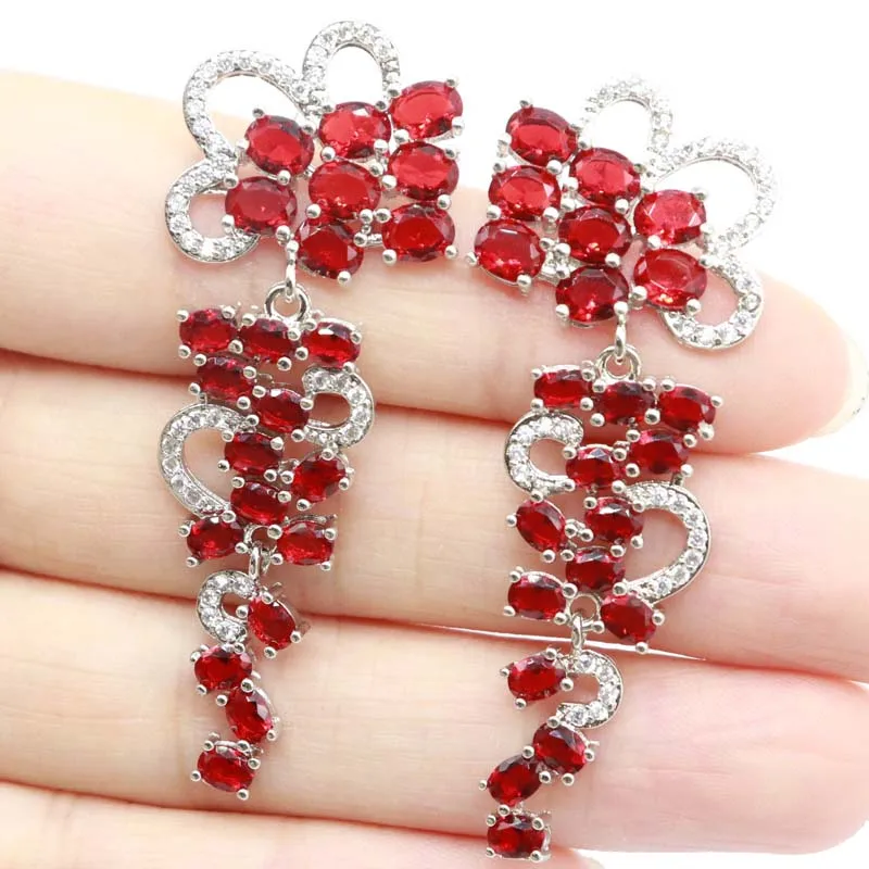 

Серебряные женские серьги 55x21 мм с крупными фиолетовыми шпинелями, кровавыми рубинами, родолитами, гранатами, голубыми топазами и фианитами, 9 грамм