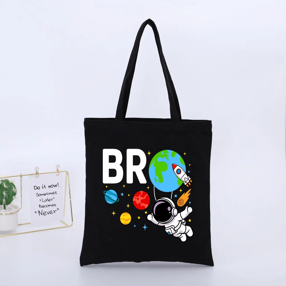 Space-themed Black Canvas Tote Bag with Astronaut and Planet Graphic, Casual Style for Daily Shopping and Outings