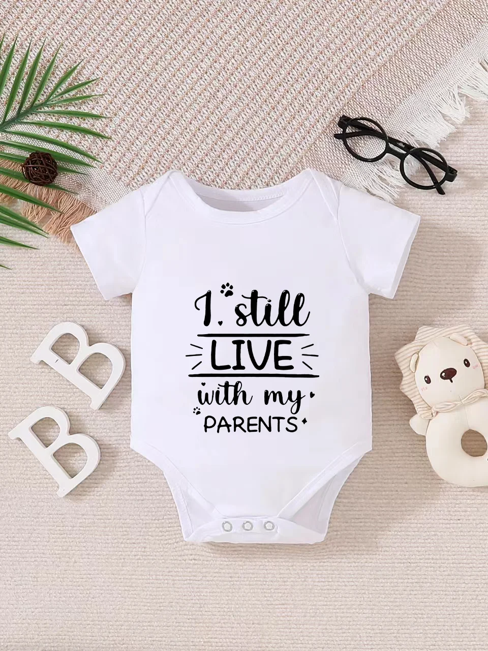 Playful letter-printed baby short-sleeve triangle bodysuit. Button closure for easy dressing, machine washable