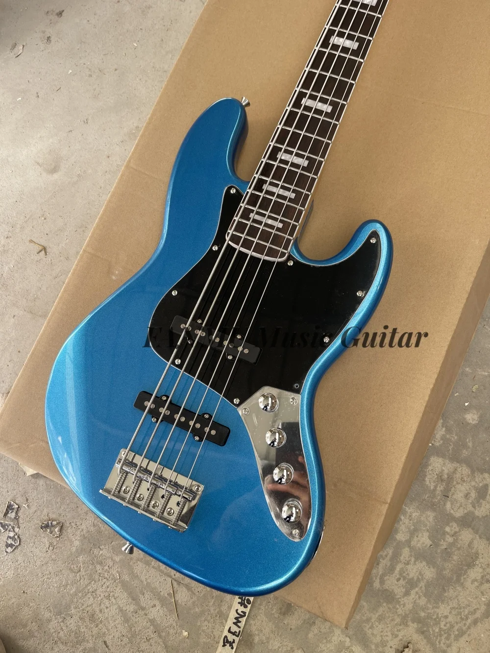 5 string Metallic blue guitar,  fixed bridge, solid wood body rosewood fingerboard, black pickup guard, active battery