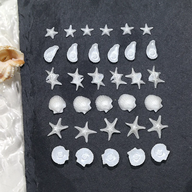 50 ชิ้น ของตกแต่งเล็บเรซิ่นรูปปลาดาวเปลือกหอยมุกสีขาวมุกประกาย น่ารัก สไตล์โอเชียน สำหรับตกแต่งเล็บ