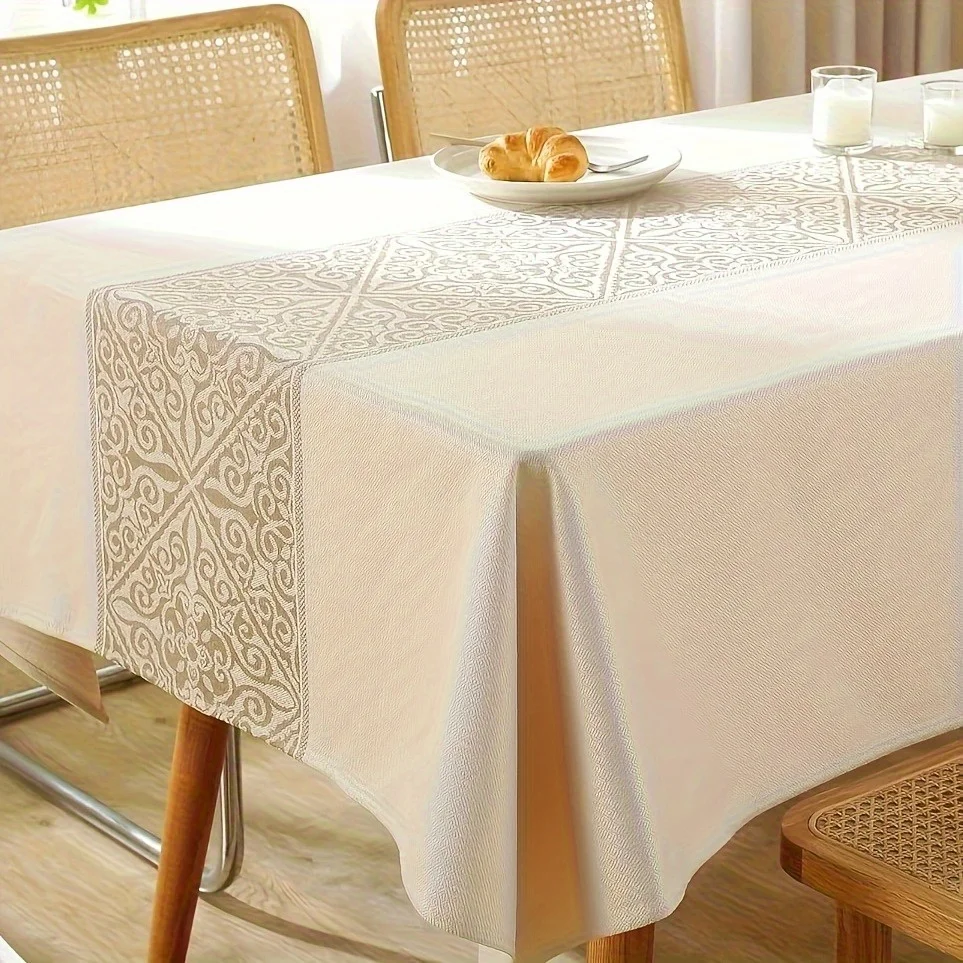 The elegant linen tablecloth features geometric floral patterns on a rectangular table.