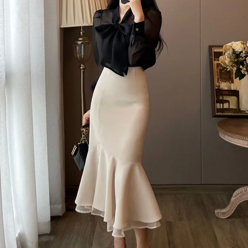 French suit skirt women's early spring 2024 new black long-sleeved shirt high purse hip fishtail skirt two-piece.