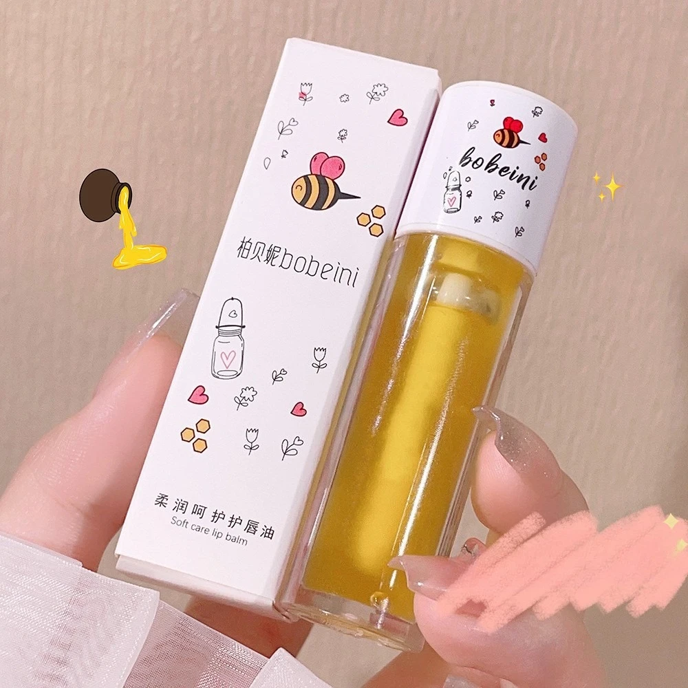 1Pc Olio per labbra al latte di pesca Balsamo per labbra ape Balsamo per labbra idratante Olio per labbra lenitivo e idratante Ripara facilmente il trucco delle labbra secche e screpolate
