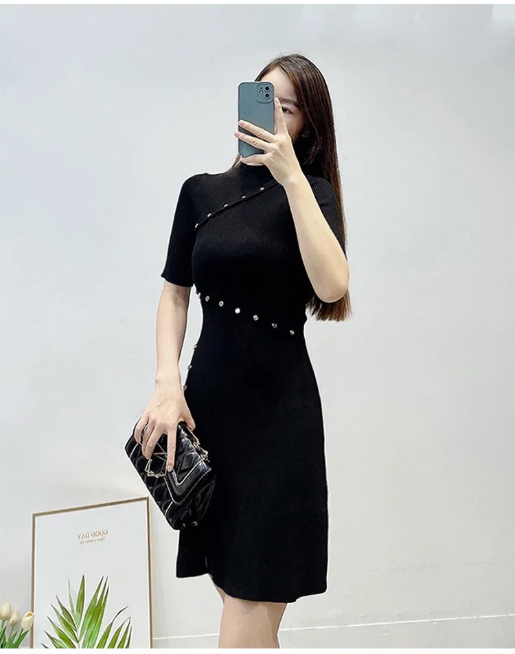 New French style commuting black ribbed short sleeved dress with waist cinching buckle and short sleeved knitted dress