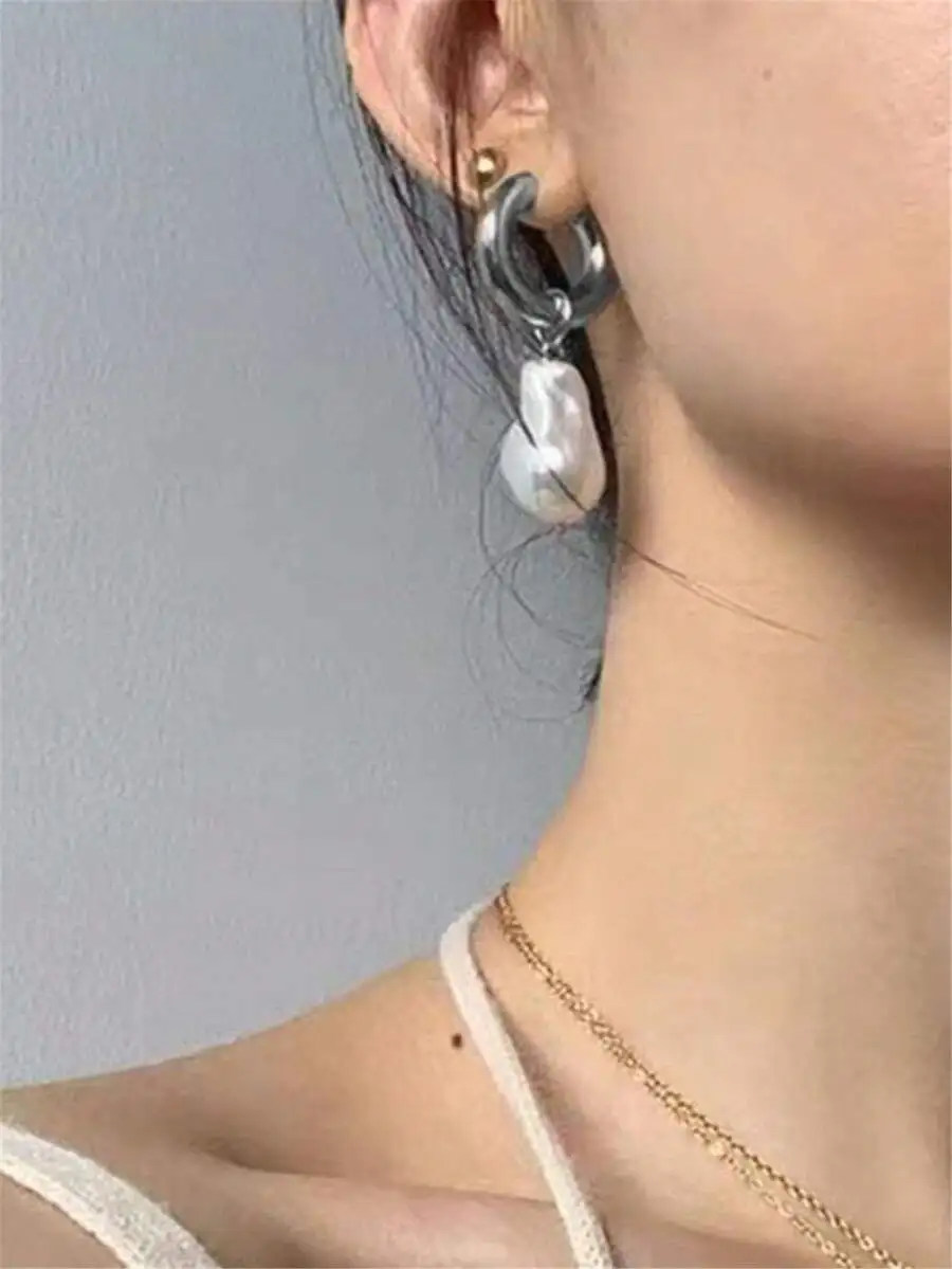 

Baroque-inspired faux pearl pendant hoop earrings with elegant curved design and lustrous simulated pearls