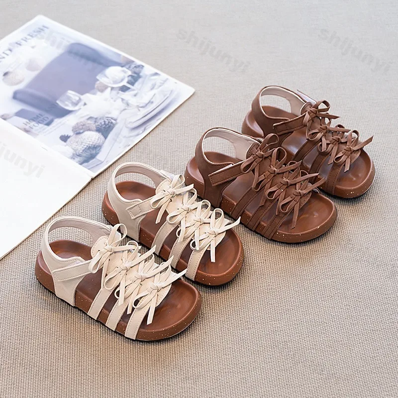 

2025 Summer Girl Hollow Lace Up Roman Style Shoes Childrens' Retro Bow Design Fashion Versatile Thick Soled Beach Casual Sandals