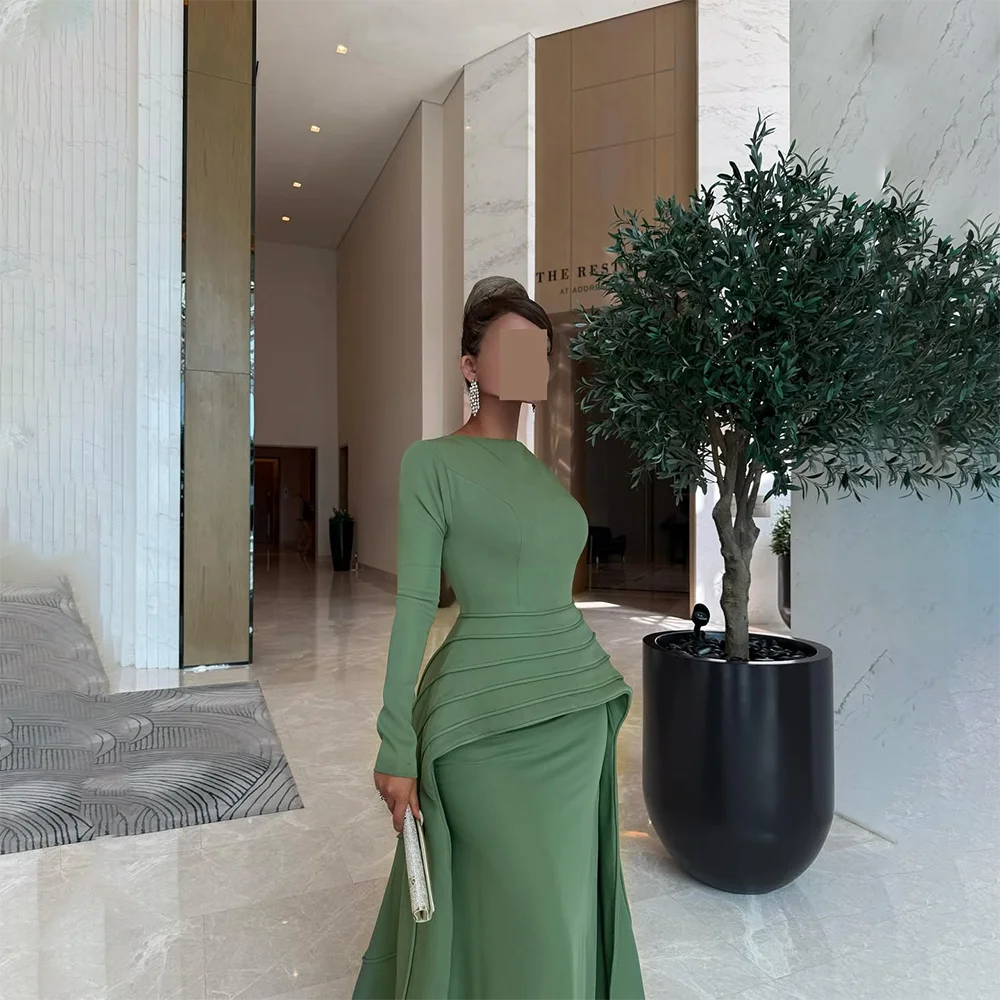 ชุดราตรีสีเขียวแบบสั่งตัด คอทรงโอ แขนยาว ทรงเมอร์เมด กระโปรงยาวทรงทรัมเป็ตจีบระบาย ชุดราตรีออกงานปี 2025