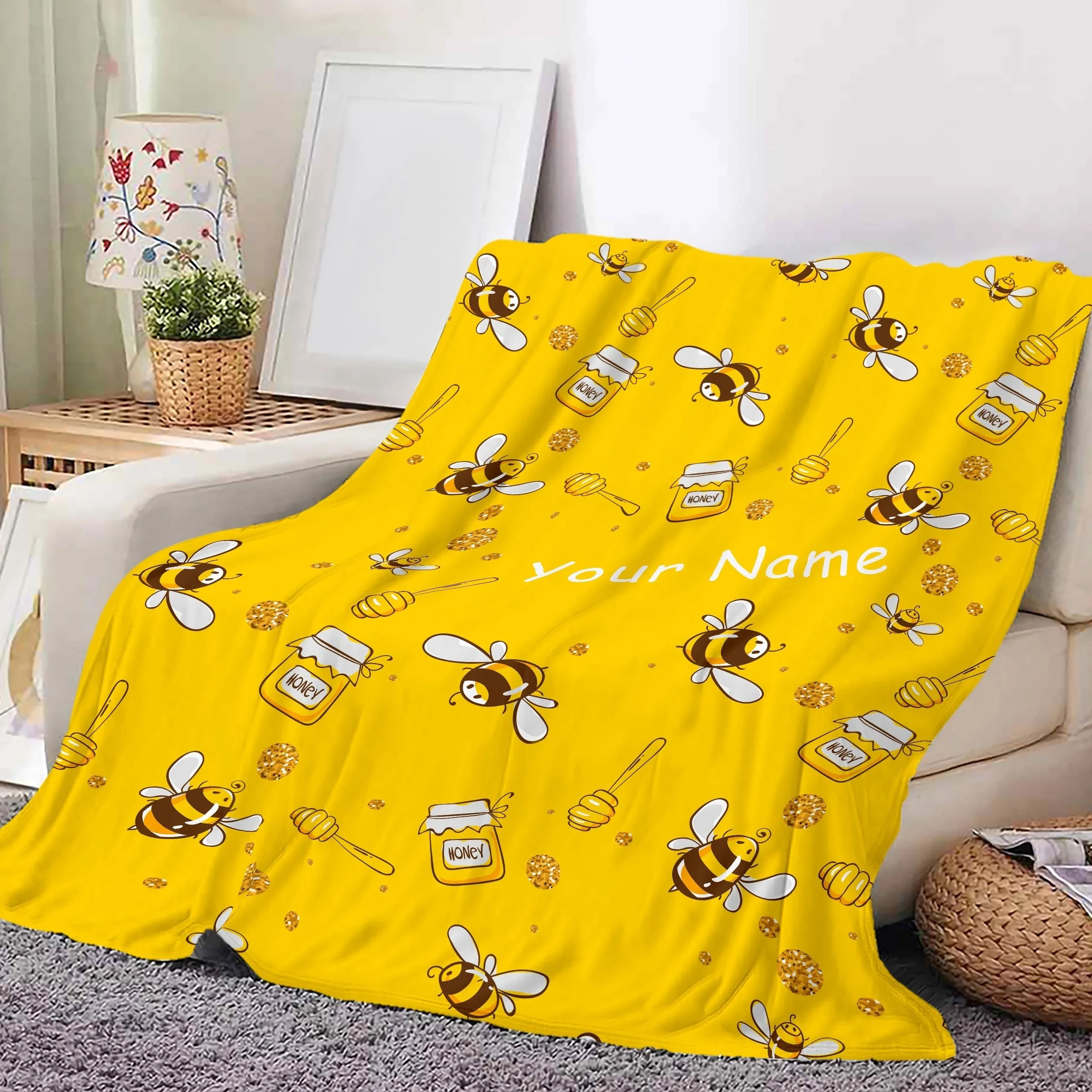 A gold country style bee and honeycomb patterned blanket with reversible knitted flannel polyester office nap and multifunctiona