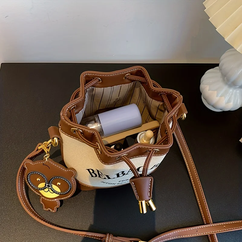 Chic Canvas Bucket Bag with Letter Design - Crossbody & Shoulder Style with Pendant, Drawstring Closure for Everyday Use